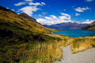 Scenic view of sea and mountains against sky