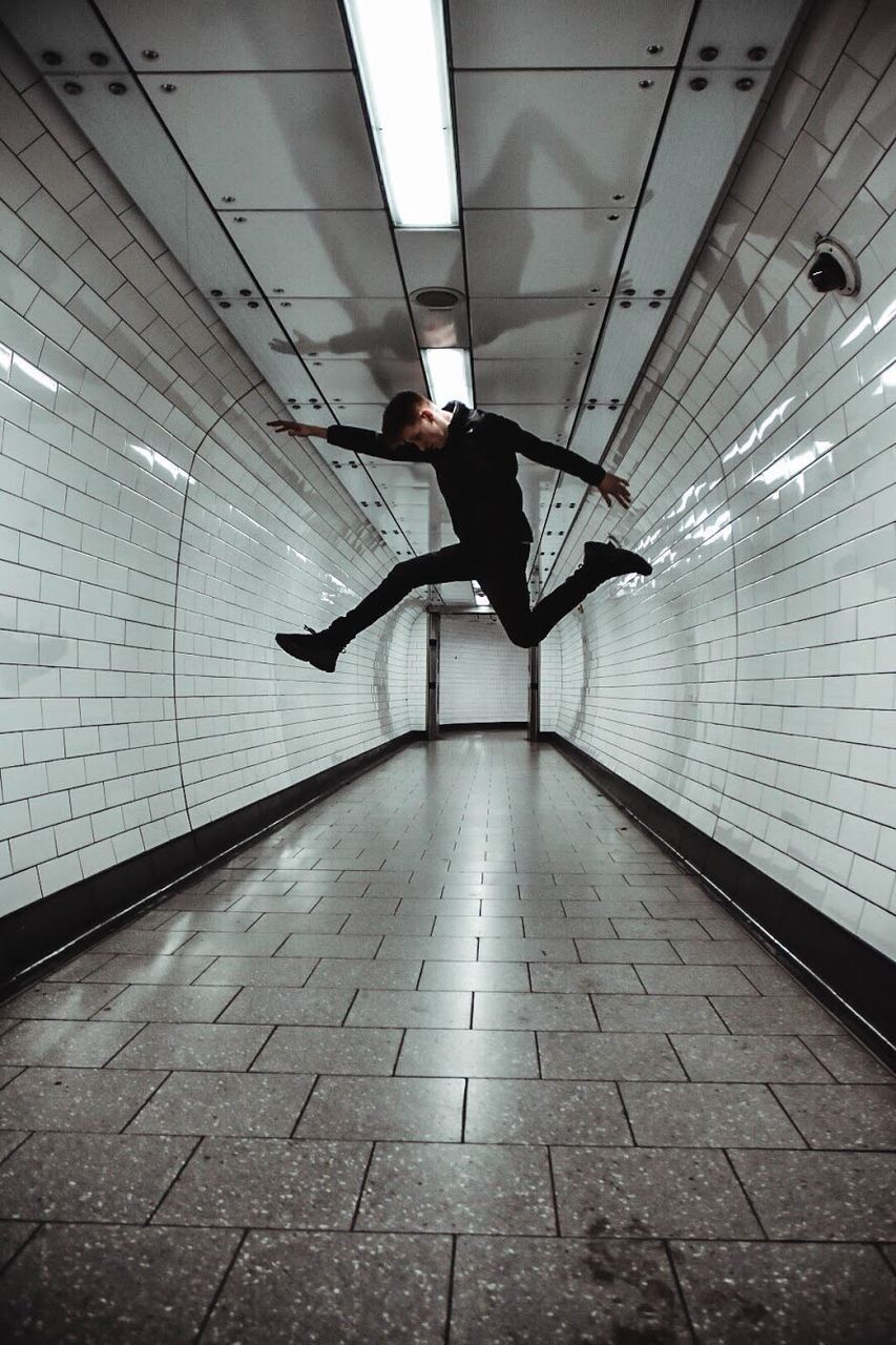 MAN STANDING IN CORRIDOR