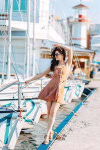 Full length portrait of young woman in boat