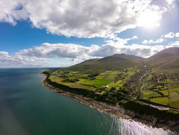 Scenic view of sea and mountains against sky