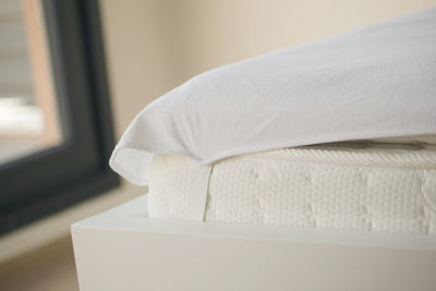 Close-up of towels on bed at home