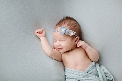 Cute baby girl sleeping on bed