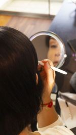 Rear view of woman looking at camera