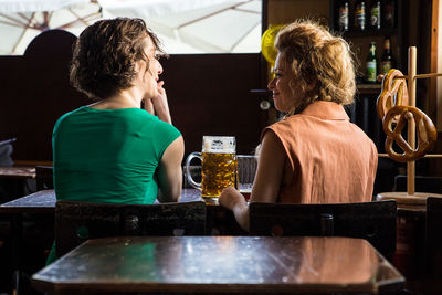 Young woman drinking glass on table