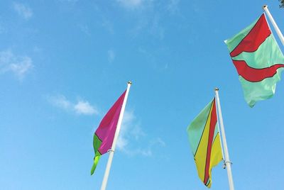 Low angle view of american flag against blue sky