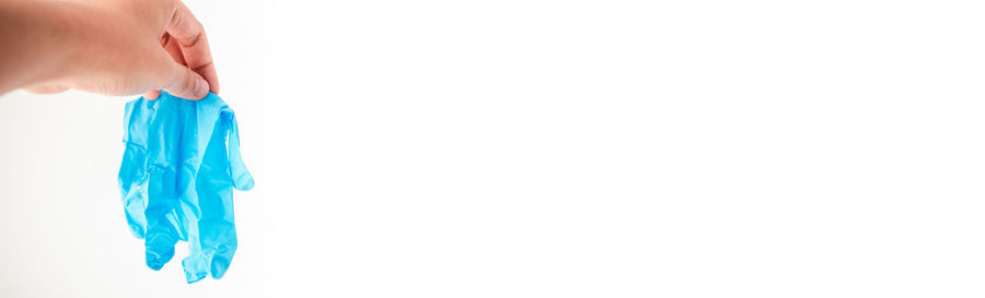 Midsection of woman holding hands against white background