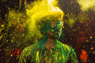 Man with colorful powdered paint during holi