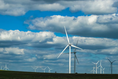 Windmill on field against sky