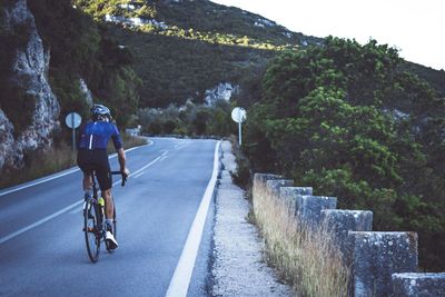 Man riding bicycle on road