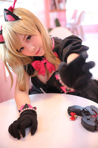 Portrait of young woman in costume sitting at cafe