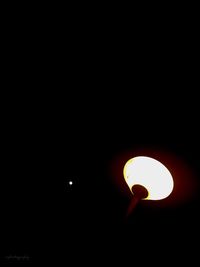 Low angle view of illuminated moon against sky at night