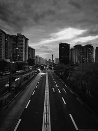 High angle view of vehicles on road against cloudy sky