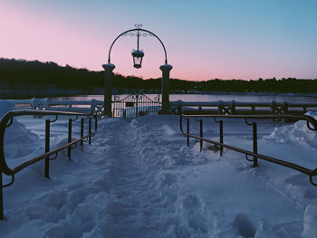 Scenic view of frozen lake against sky at sunset