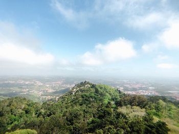 Scenic view of green landscape against sky