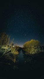 Scenic view of lake against sky at night