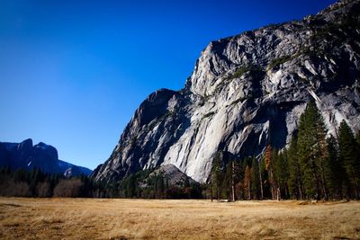 Scenic view of rocky mountains against clear blue sky