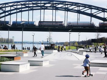 People walking on bridge in city