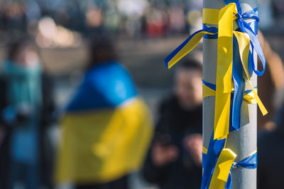 Ribbons with colors of ukraine during a peaceful demonstration against war, putin and russia