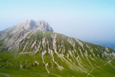 Scenic view of mountains against clear blue sky