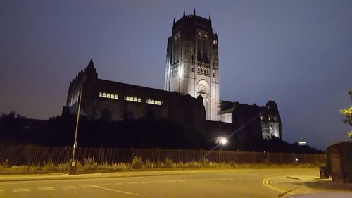 Illuminated building against sky at night