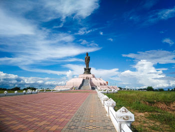 View of building on field against cloudy sky