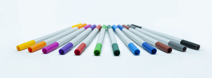 Close-up of colored pencils against white background