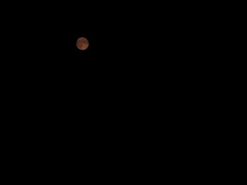 Low angle view of moon against sky at night