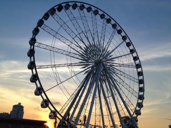 Low angle view of ferris wheel against sky