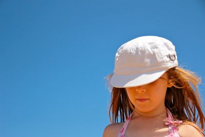 Woman wearing hat against blue sky