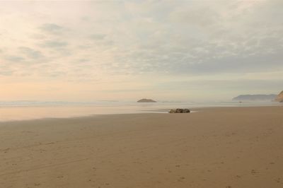 Scenic view of beach against sky during sunset