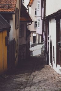 Empty alley amidst buildings in town