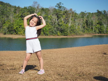 Portrait of happy girl standing in water