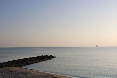 Scenic view of sea against clear sky during sunset