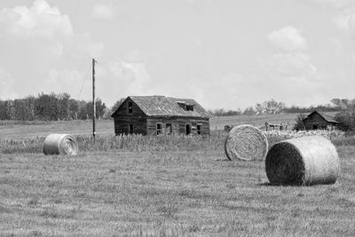 Hay bales on field against sky