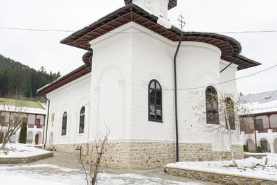 Building against sky during winter