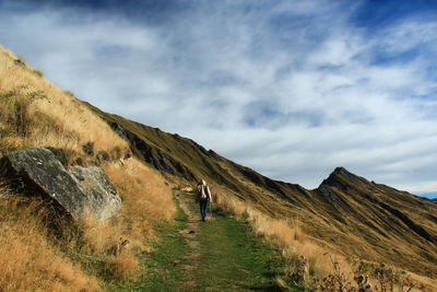 Rear view of woman walking on land