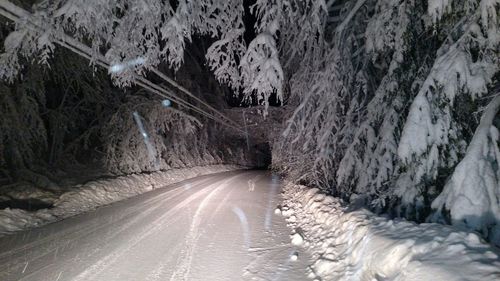 Road passing through snow covered landscape