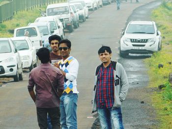 Men standing on road in city