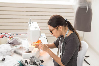 Side view of woman working on table