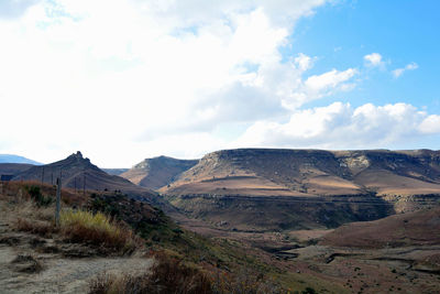 Scenic view of mountains against cloudy sky