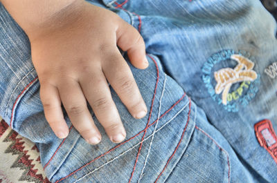 Midsection of boy wearing jeans