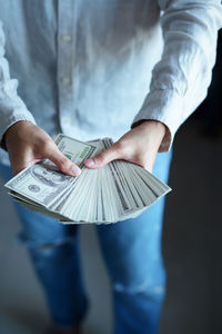 Midsection of man holding umbrella