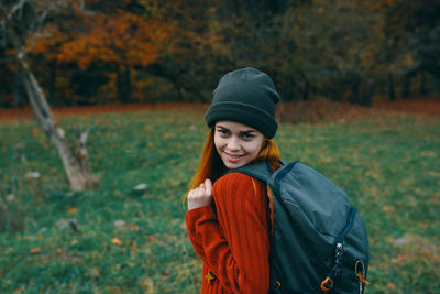 Portrait of beautiful young woman in park during autumn