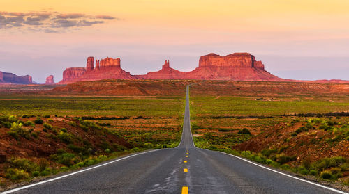 Road amidst rocks against sky