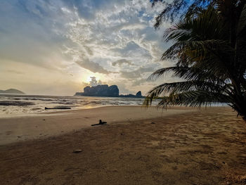 Scenic view of beach against sky during sunset