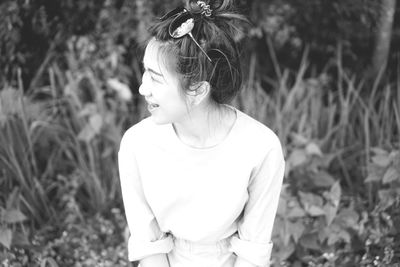 Girl looking away while standing on field