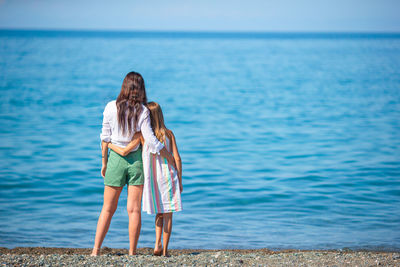 Rear view of woman standing on beach