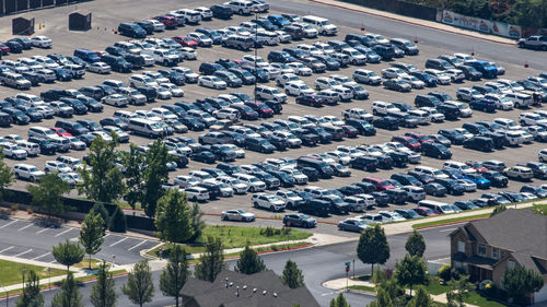 High angle view of cars on street amidst buildings in city