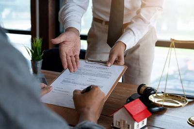 Midsection of business colleagues working on table