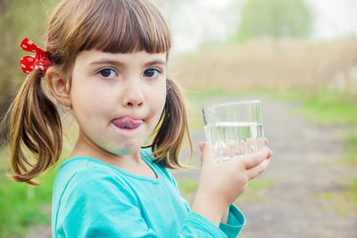 Portrait of young woman having drink